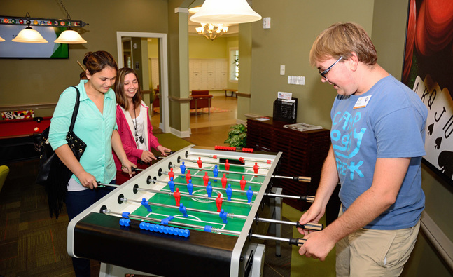 The Arc Jacksonville Village is an affordable, independent living, apartment–style neighborhood designed to maximize community inclusion for adults with intellectual and developmental disabilities (I/DD). The atmosphere of the community encourages independent living, promotes socializing and sharing among neighbors, and lends itself to venturing beyond the property to enjoy the educational, employment, social, and recreational opportunities found in the thriving metropolitan Jacksonville area. The Arc Jacksonville Village environment promotes resident freedom, inclusion, and integration within the Jacksonville community, in a way that has previously not been possible. 

Potential residents undergo a services eligibility process (please click here to learn more: http://www.arcjacksonville.org/the-arc-village-eligibility-and-application/)   sign their own leases (some may require a guarantor), determine the type and level of independent living/employment services, define their own lifestyle, make their own decisions and enjoy the same freedoms as anyone else without an I/DD diagnosis. 

It is important note that The Arc Jacksonville Village is ** NOT ** a:
Glorified Group Home
Special City
Facility/Institution
Residential Program

Although The Arc Jacksonville Village offers a more connected community, independent living/community-based employment services, natural supports and volunteers and fun and meaningful on/off-site recreation/leisure/wellness activities, the expectation is for residents to create a life outside of the community grounds and provided services and activities. The Arc Jacksonville Village is NOT designed to provide any supervision and/or care.

The Arc Jacksonville Village ** IS ** designed to:
Connect residents with customized and needed government and community resources and benefits
Provide services that optimize inclusion, integration, and self-determination of residents.

Provide opportunities to increase and enhance independent living skills, decision-making, safety, wellness/medical management, employment, self-advocacy, community access, civic responsibility, and “sense-of-self”.

Offer independent living skill-building that leads to the need of very minimal supports in long-term independent living planning.

Realize the full potential of residents to live full, meaningful, and independent lives.

Transform society’s misconceptions of the abilities, capabilities, and “deficits” of persons with I/DD.